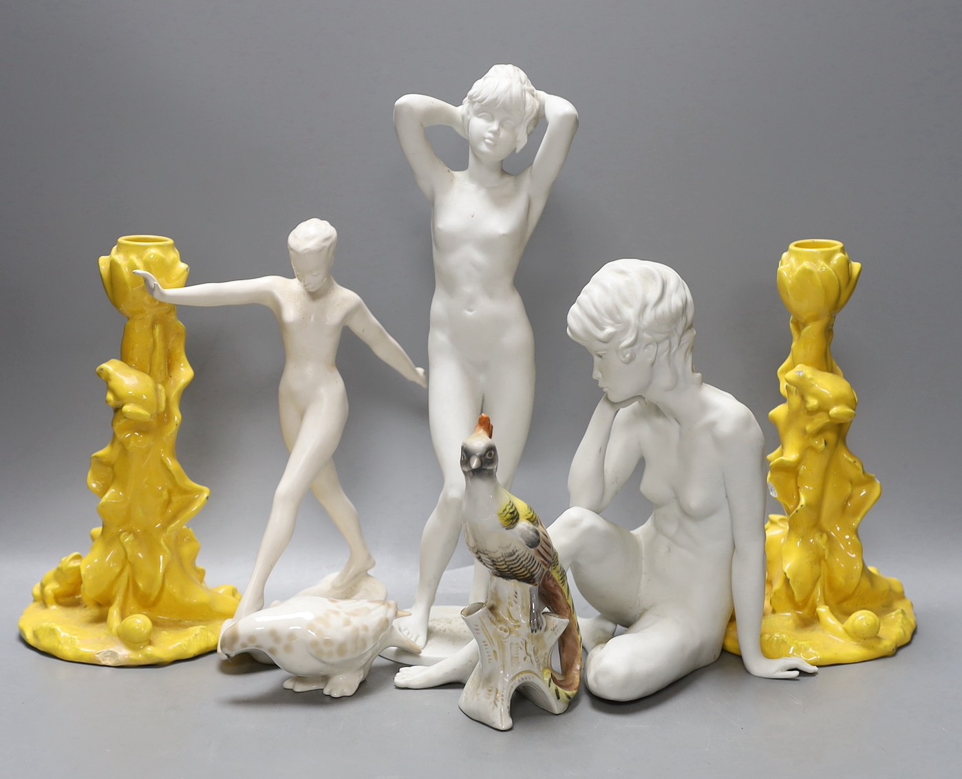 Two Kaiser porcelain figures, a Goebel figure, a pair of yellow glazed candlesticks with frogs and two animal models